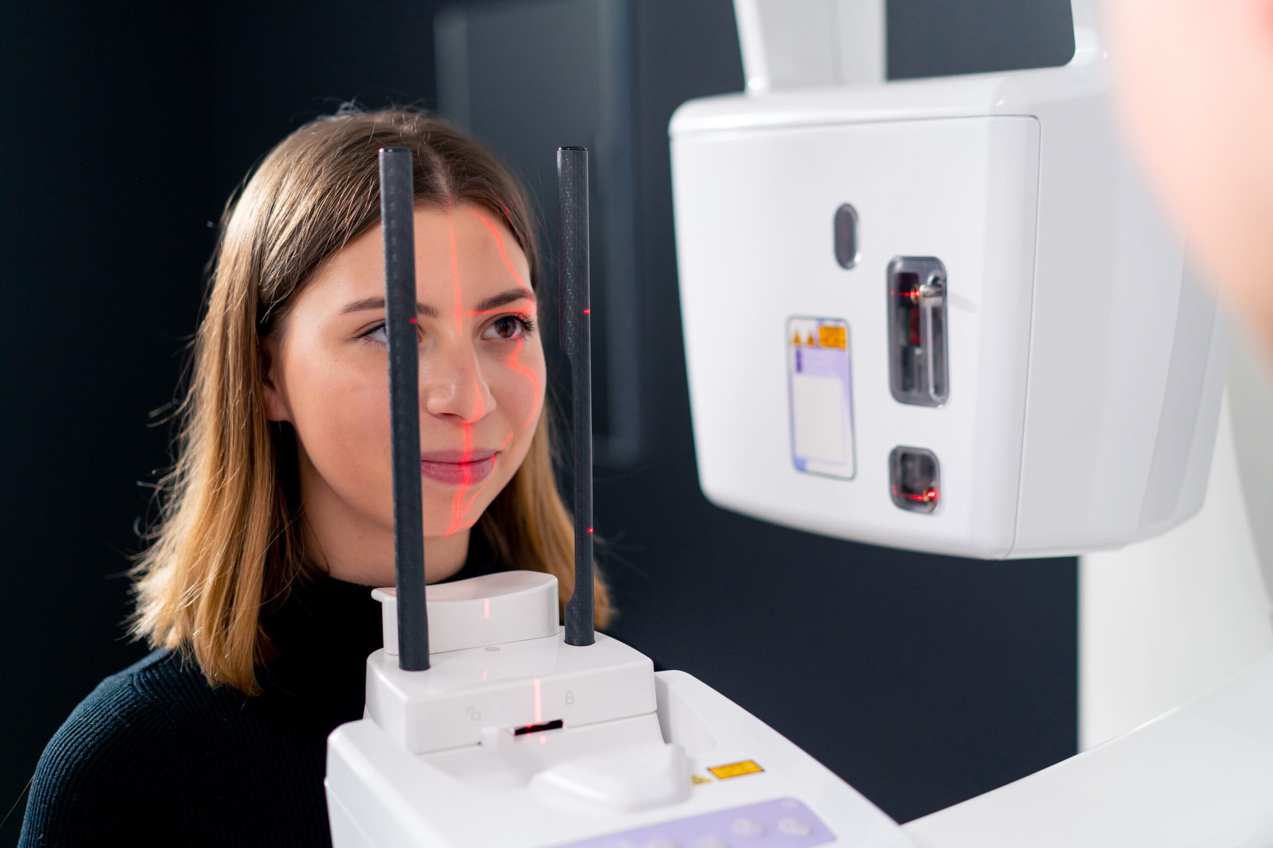 portrait of a beautiful woman doing a 3D scan of the nose and oral cavity in plastic surgery clinic