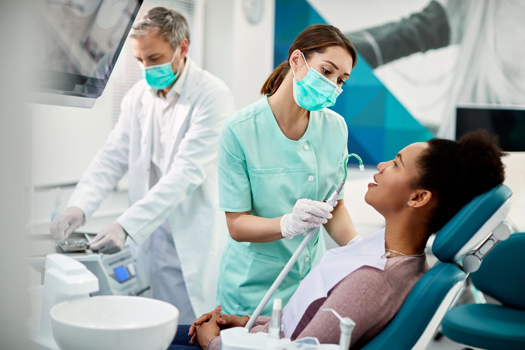 African American woman having dental treatment at dentist's office. African American woman having dental treatment at dentist's office.
