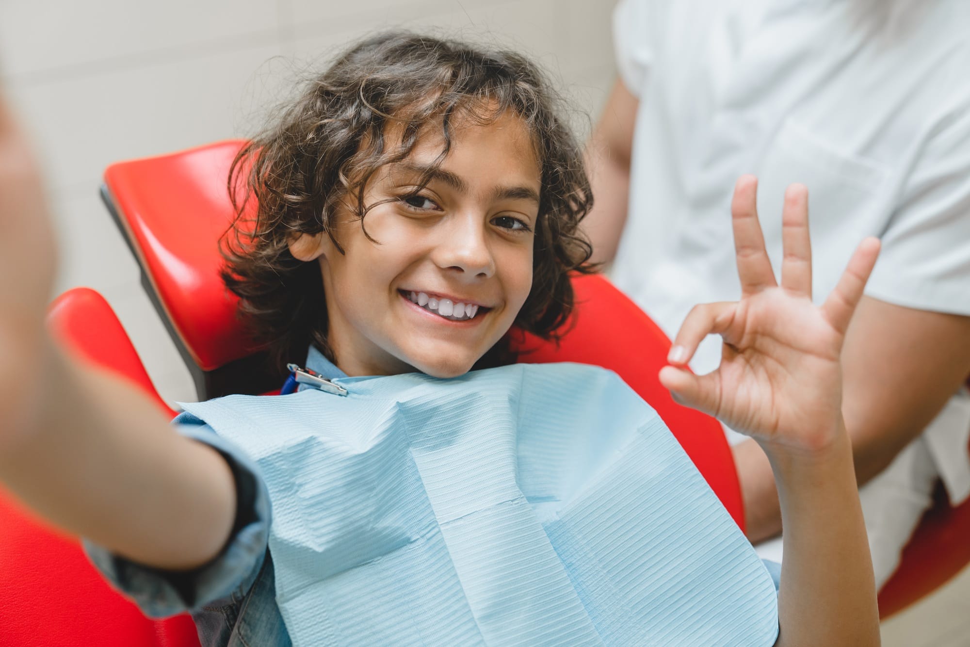 Boy taking selfie with dentist stomatologist, vlogging blogging after teeth braces correction