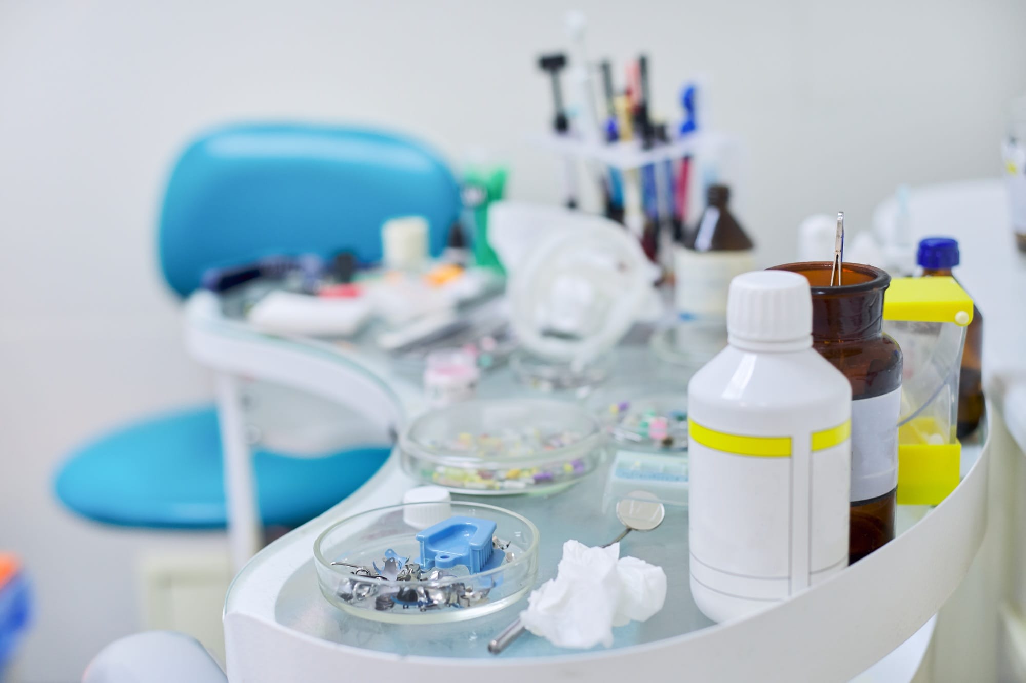 Close-up work at dentist desk, dental composite sealing materials instruments tools Close-up work at dentist desk, dental composite sealing materials instruments tools