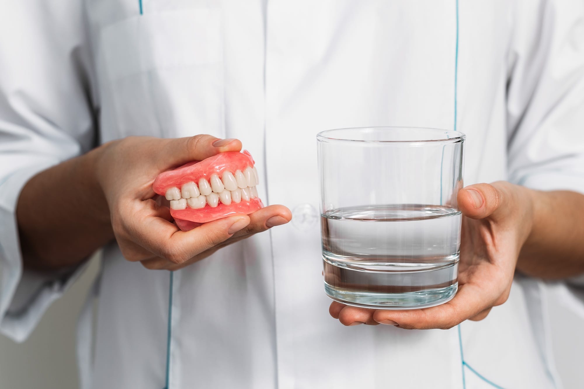 Dental prosthesis care. Full removable plastic denture of the jaws. Two acrylic dentures Dental prosthesis care. Full removable plastic denture of the jaws. Two acrylic dentures