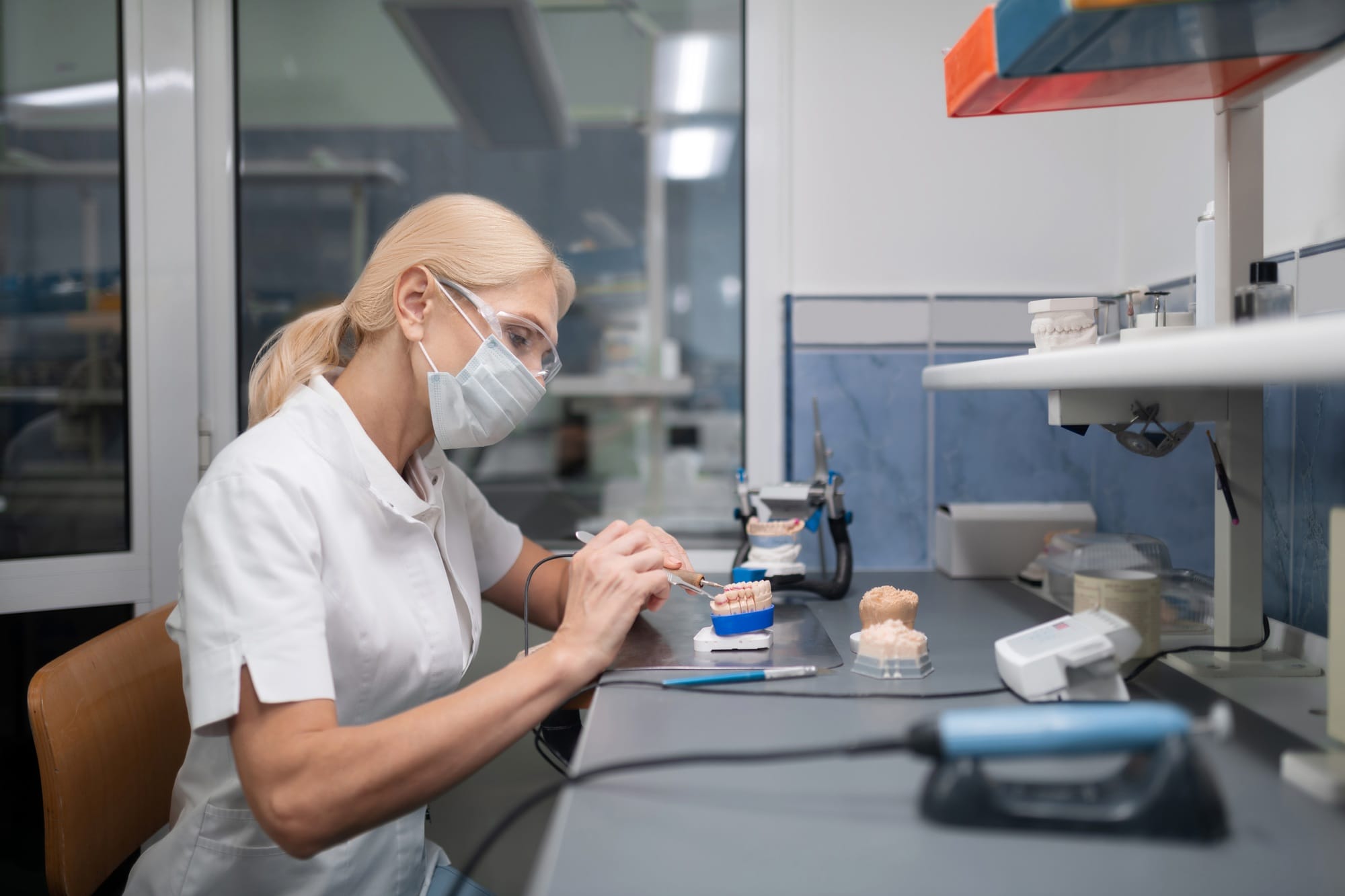 Dental technician constructing porcelain veneers for the patient Dental technician constructing porcelain veneers for the patient