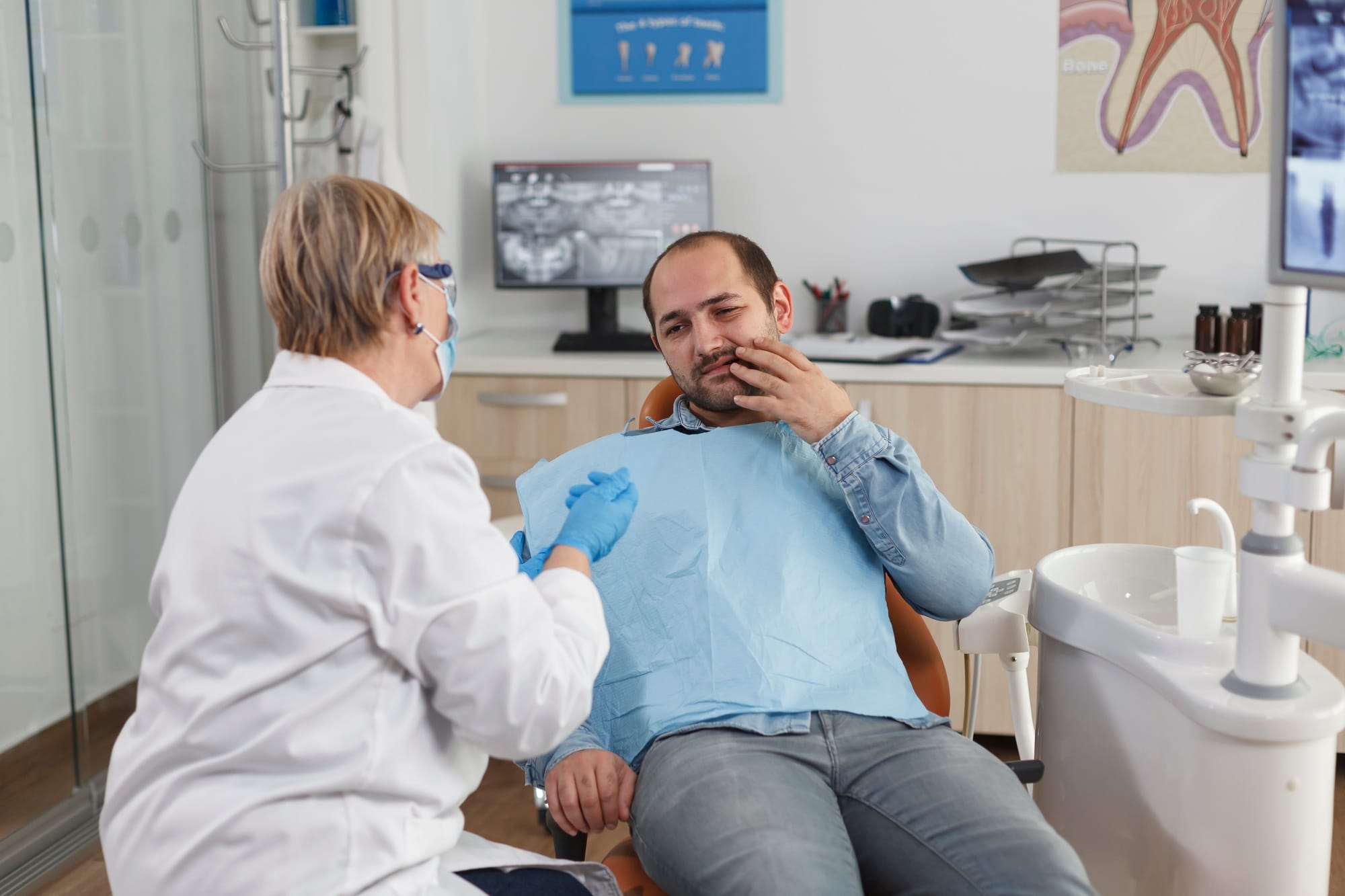 Dentist doctor explaining oral hygiene to patient with toothache