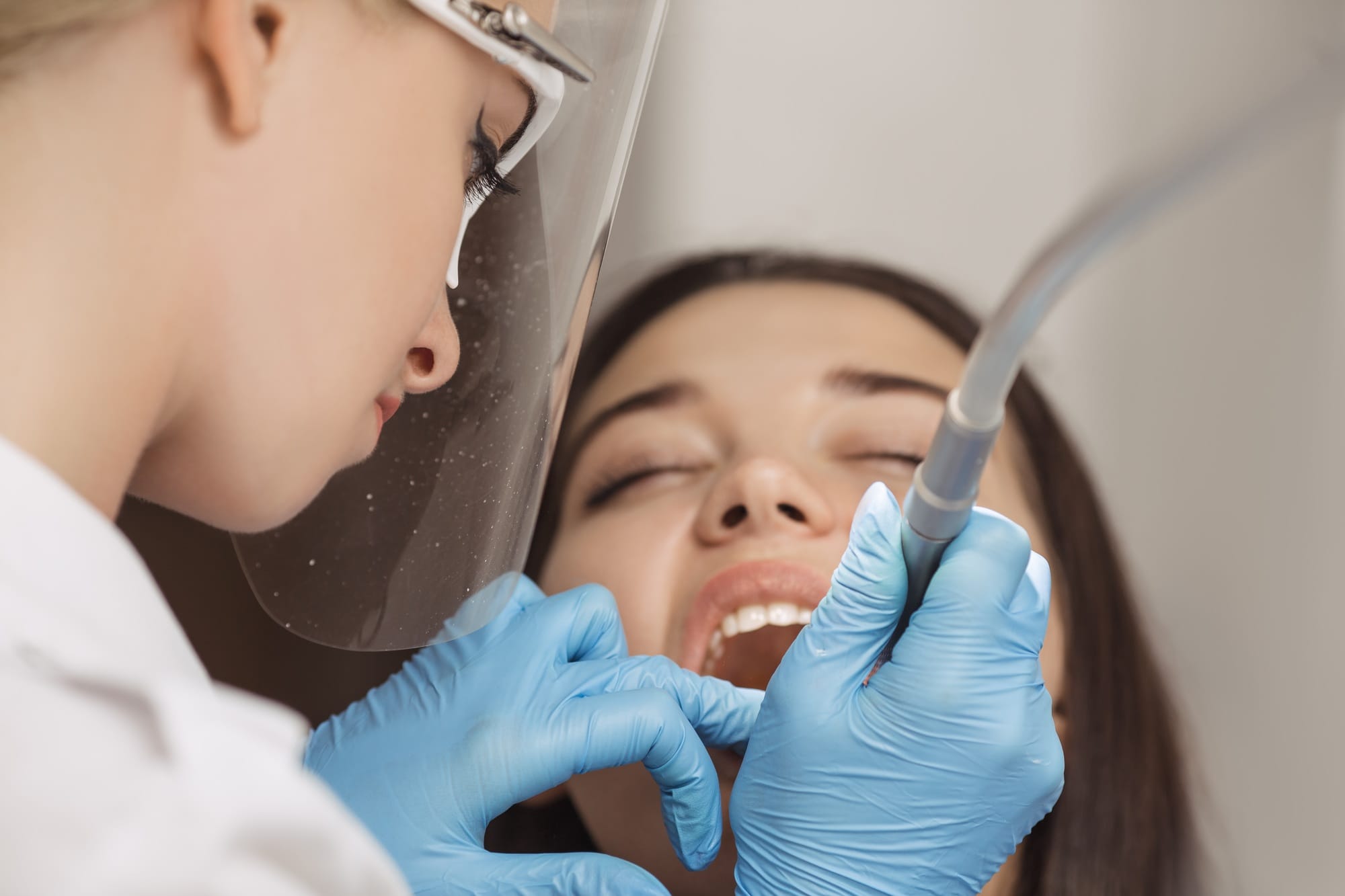 Dentist doing a dental treatment on a female patient. Dentist doing a dental treatment on a female patient.