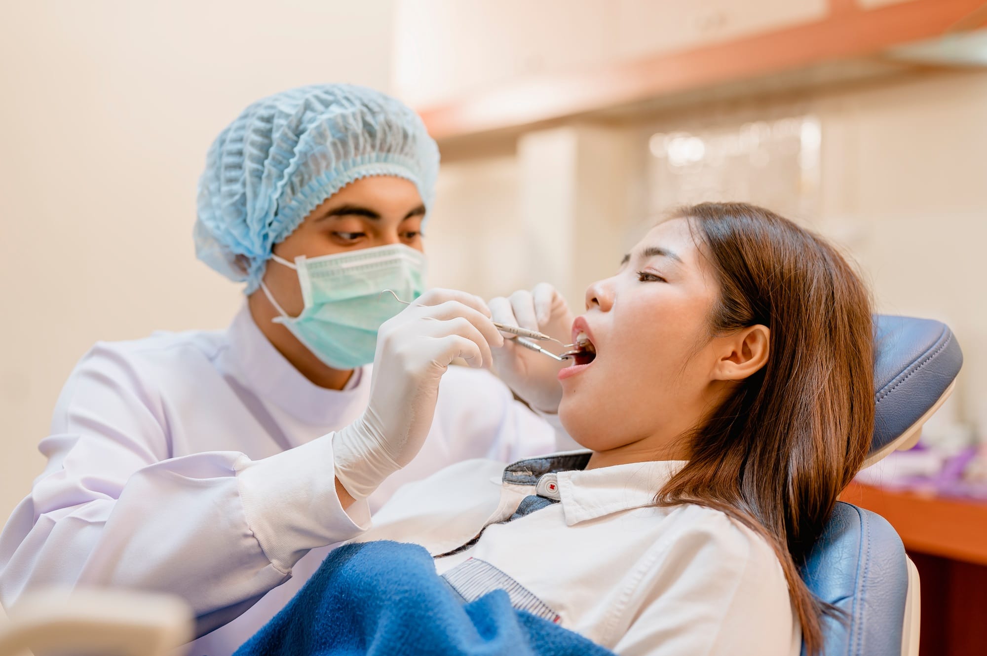 Dentist examining and filling teeth patients in clinic for better dental health and a bright smile. Dentist examining and filling teeth patients in clinic for better dental health and a bright smile.