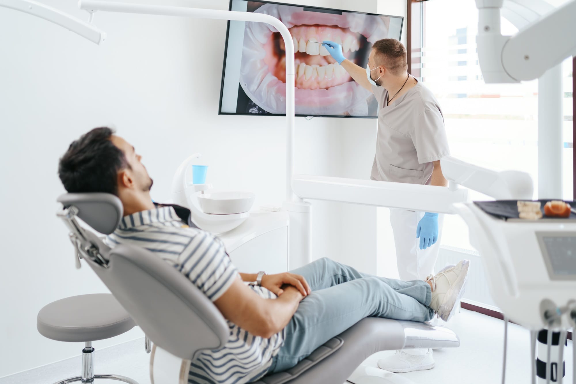 Dentist explaining teeth image on the screen Dentist explaining teeth image on the screen