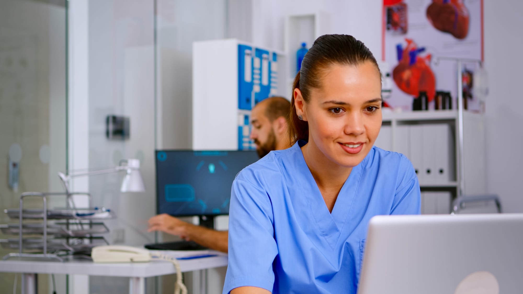 Man medical practitioner answering phone calls and scheduling appointments Man medical practitioner answering phone calls and scheduling appointments