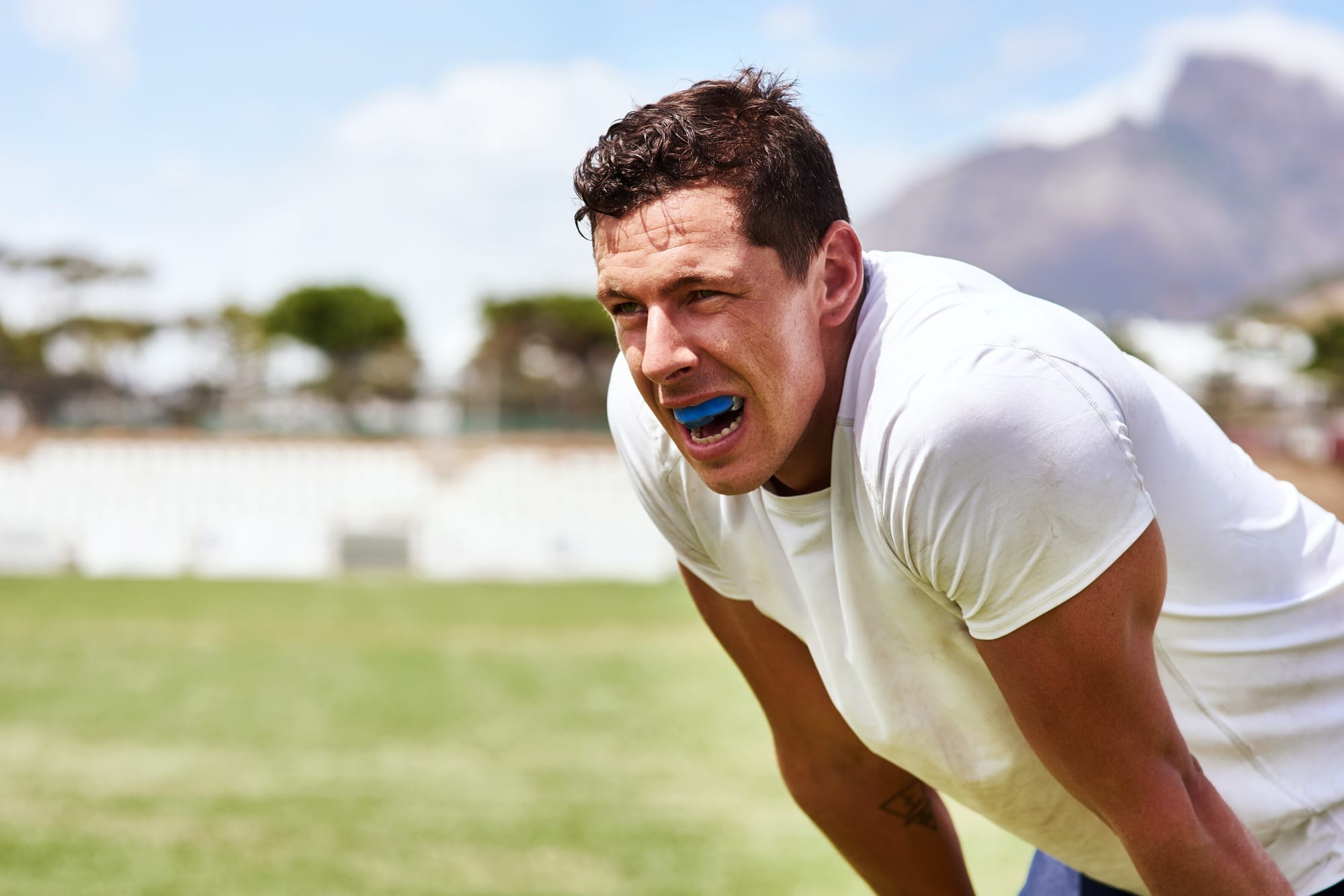 Shot of a young man wearing a gum guard while playing a game of rugby Shot of a young man wearing a gum guard while playing a game of rugby