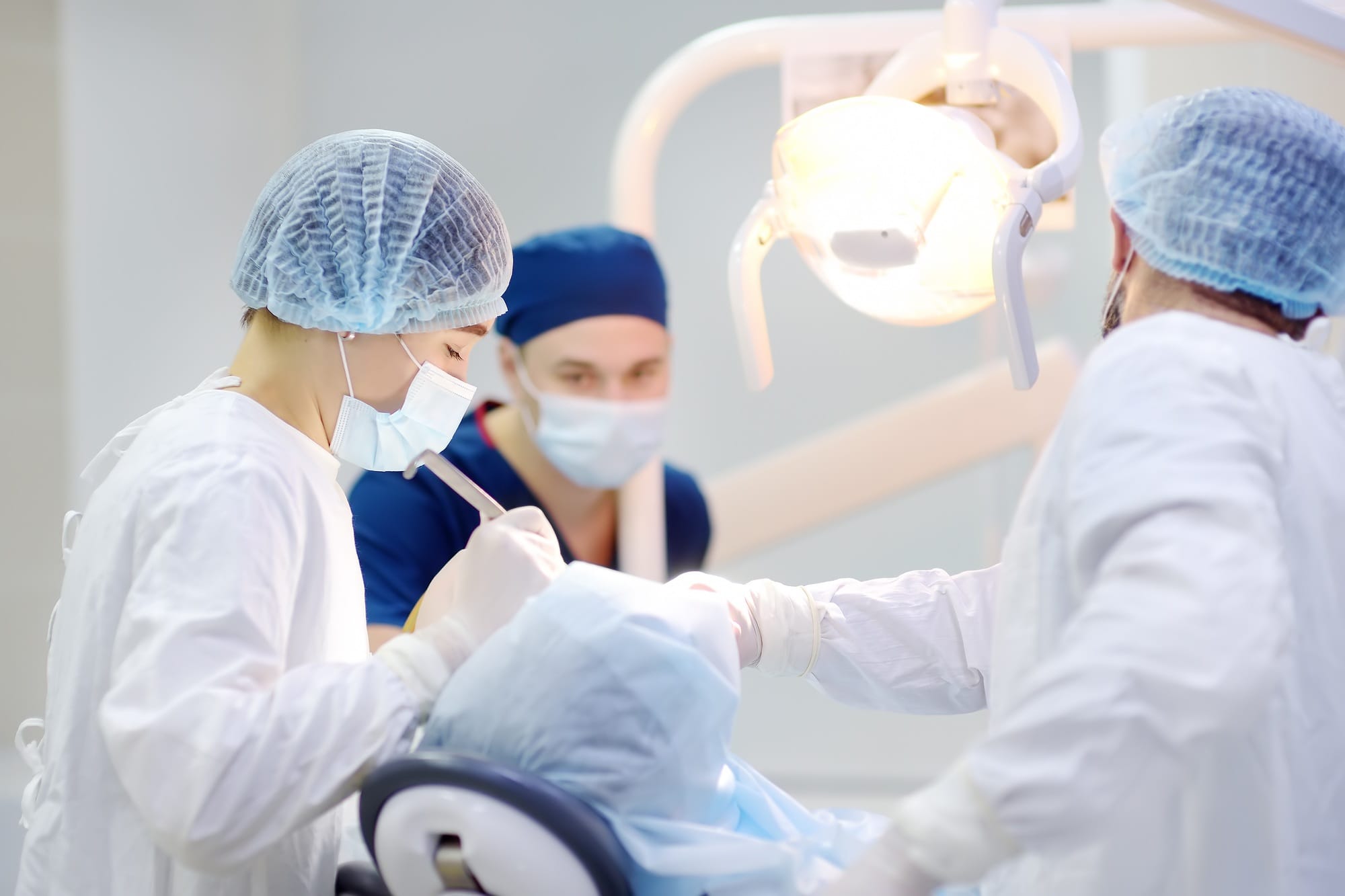 Surgeons and nurse during a dental operation. Surgeons and nurse during a dental operation.