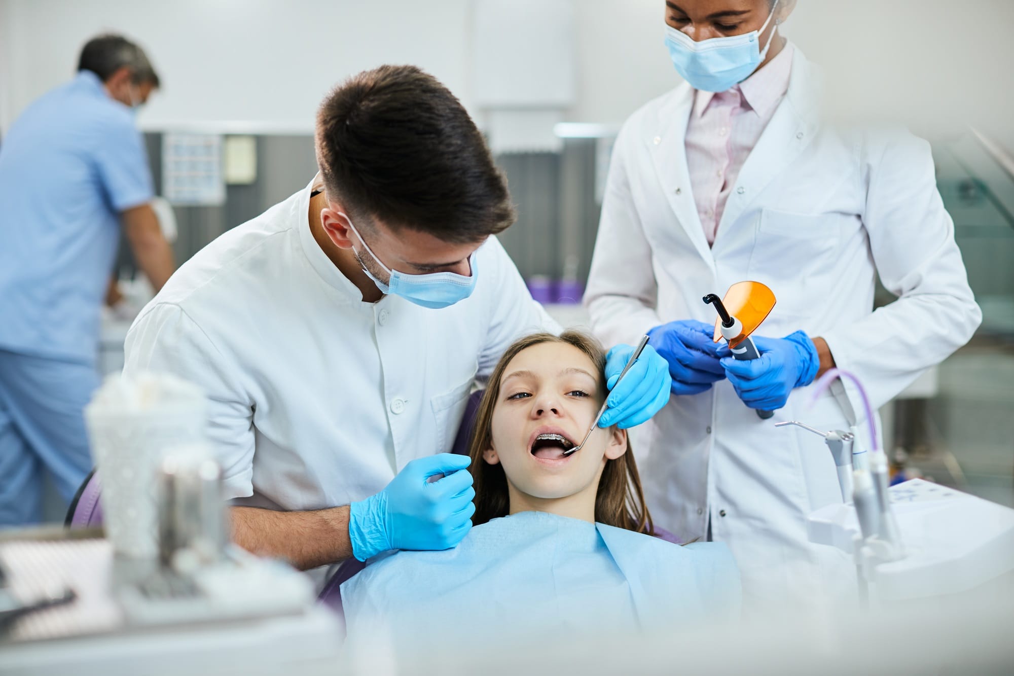 Teenage girl with dental braces having orthodontic treatment at dentist's office. Teenage girl with dental braces having orthodontic treatment at dentist's office.