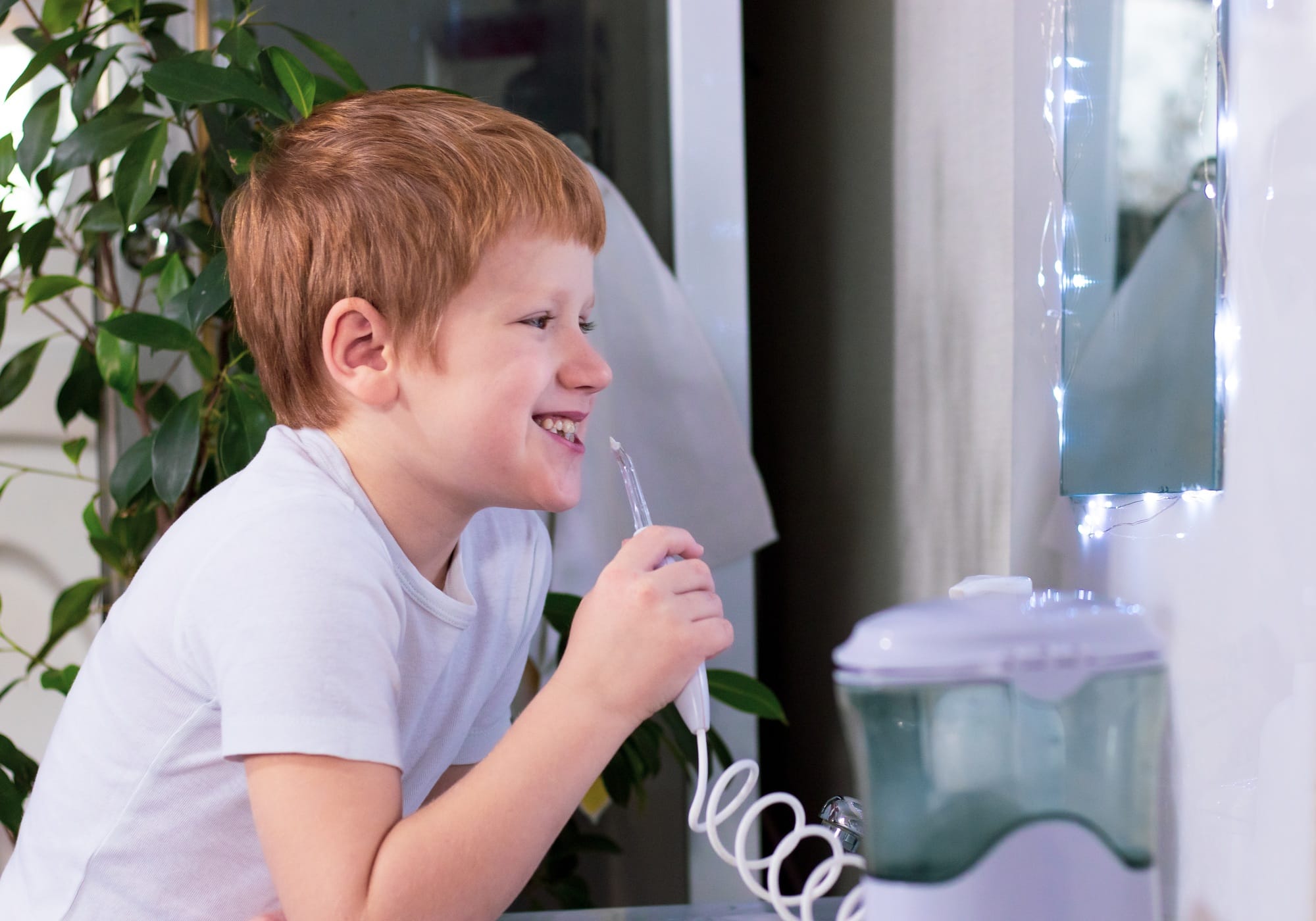 the boy is going to carry out oral hygiene with the help of an irrigator the boy is going to carry out oral hygiene with the help of an irrigator