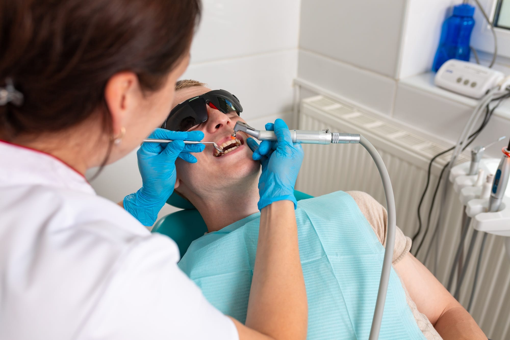 Treatment of caries. A dentist treats the patient's teeth for pulpitis. Periodontitis of the teeth. Treatment of caries. A dentist treats the patient's teeth for pulpitis. Periodontitis of the teeth.