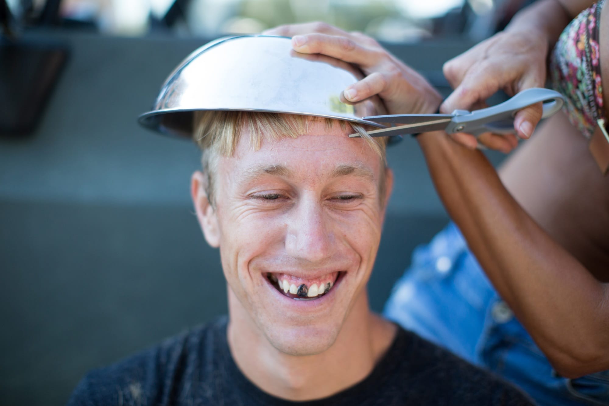 Woman cutting young man's hair using bowl, man's teeth blacked out Woman cutting young man's hair using bowl, man's teeth blacked out