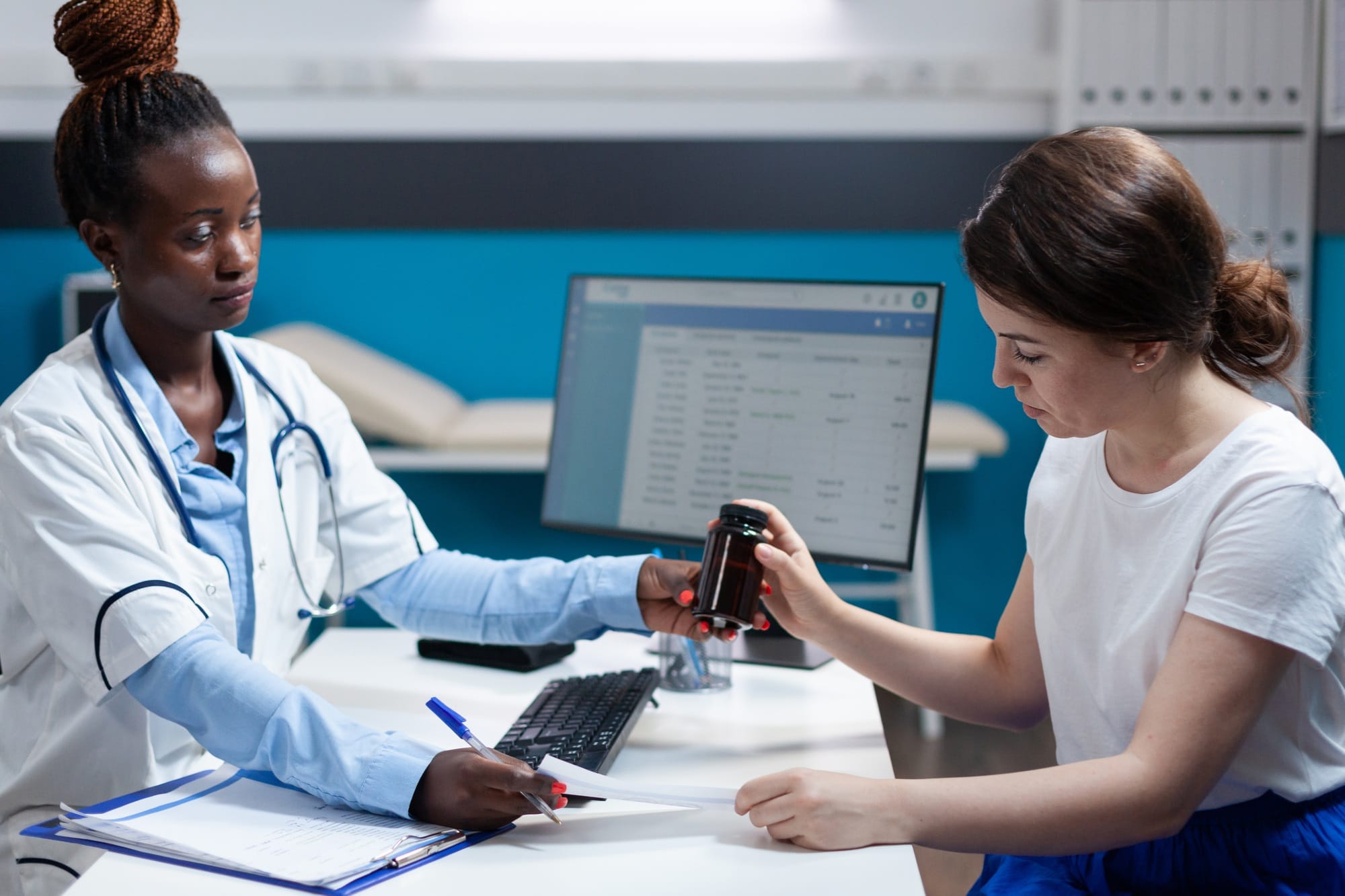 African american doctor giving antibiotic prescription to patient