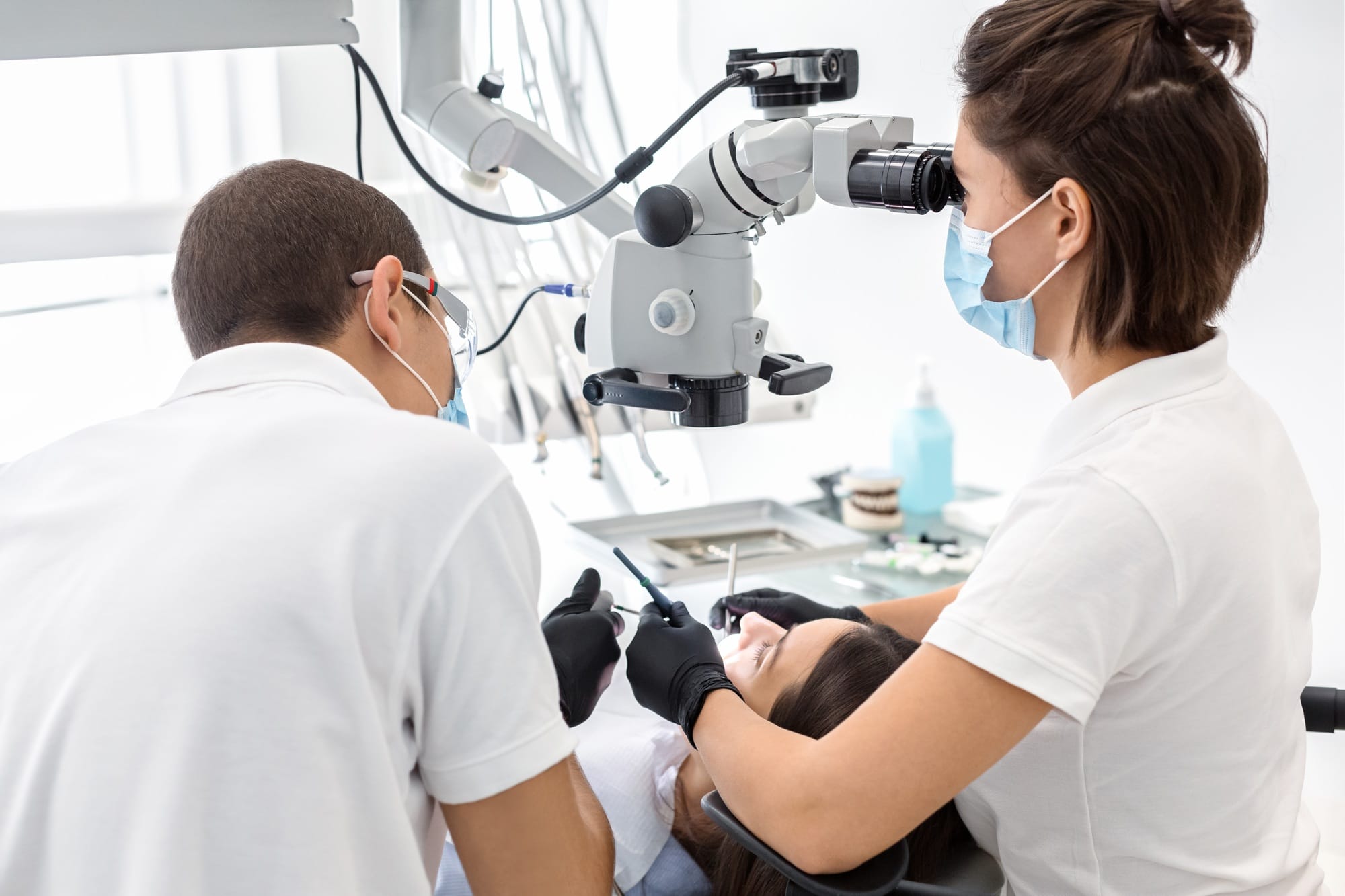 Back view of dentist doctors making dental cleaning Back view of dentist doctors making dental cleaning