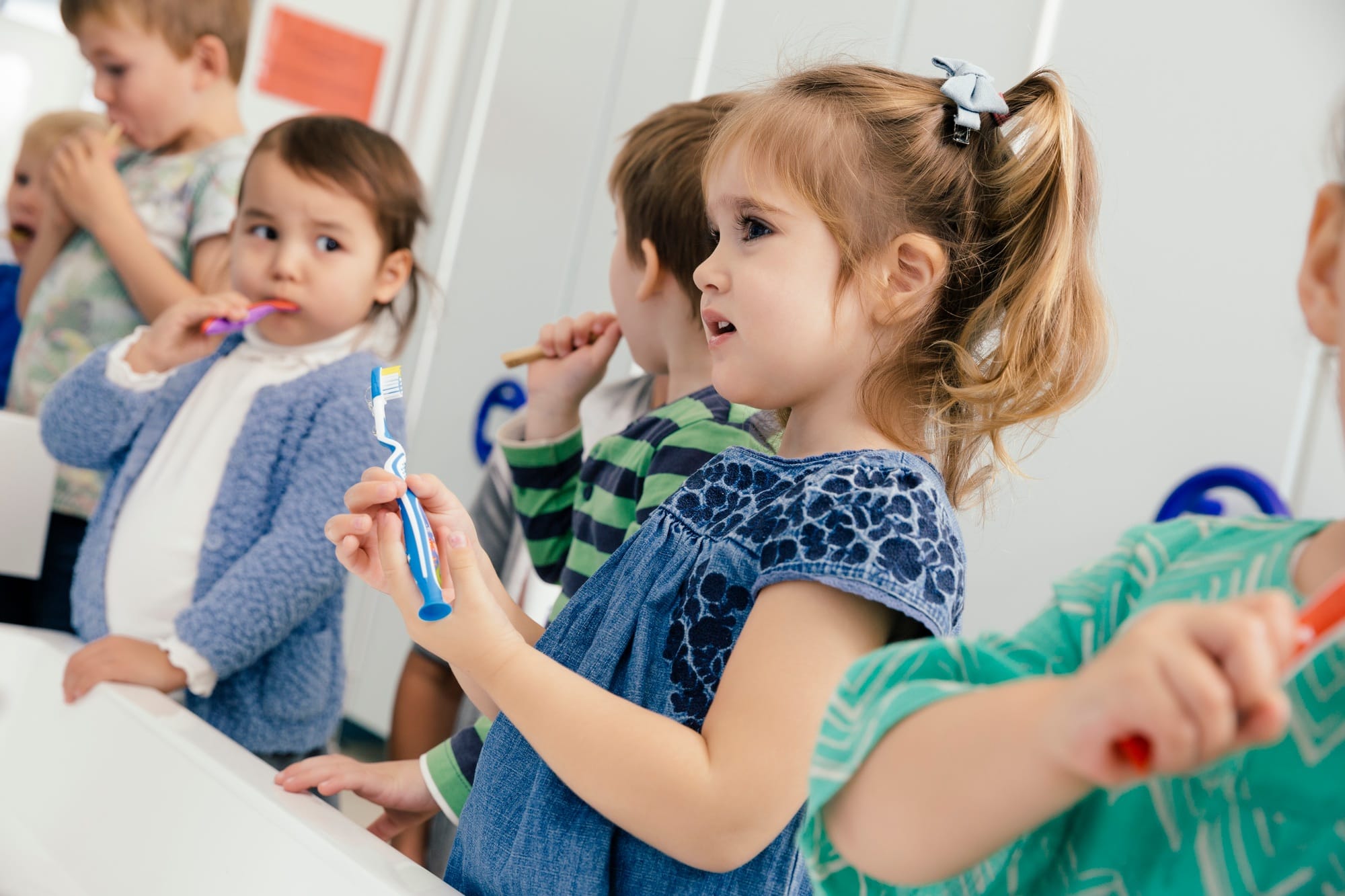 Children brushing their teeth in bathroom of a kindergarten Children brushing their teeth in bathroom of a kindergarten