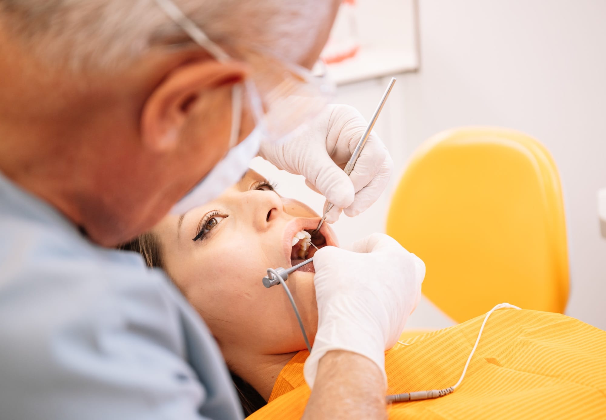Crop dentist injecting anesthetic into patient gums Crop dentist injecting anesthetic into patient gums
