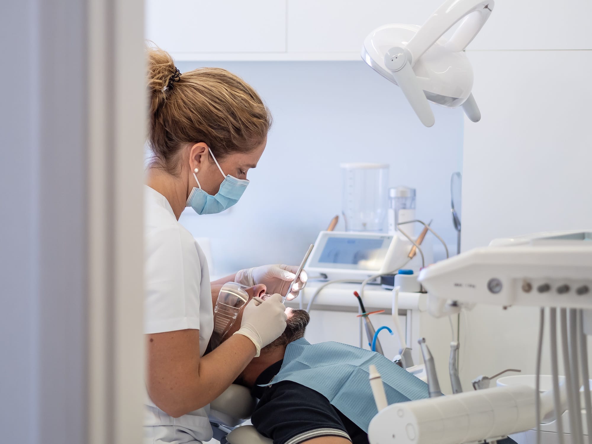 Dental hygienist performs cleaning procedure on patient at clinic Dental hygienist performs cleaning procedure on patient at clinic