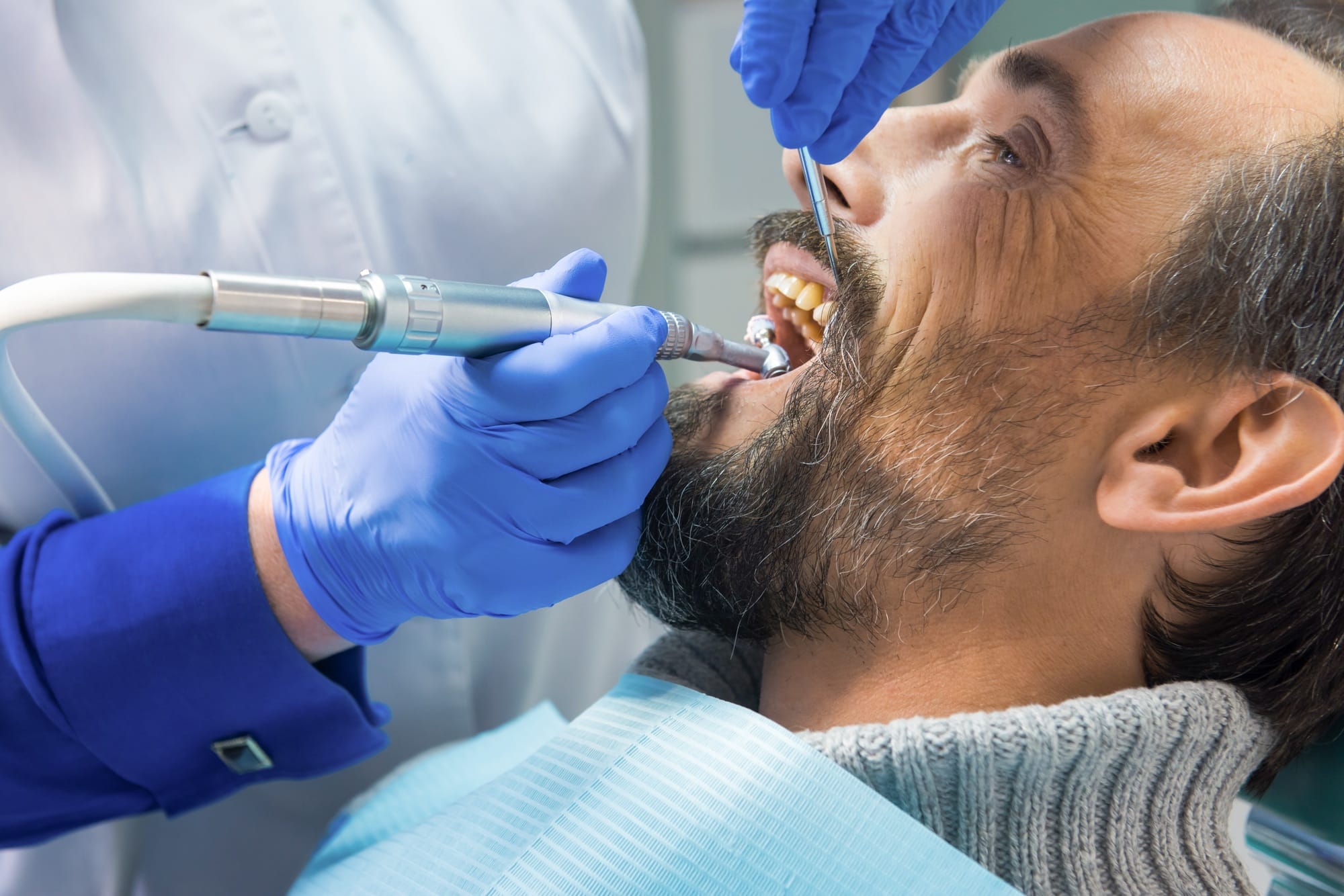 Dentist cleaning teeth Dentist cleaning teeth