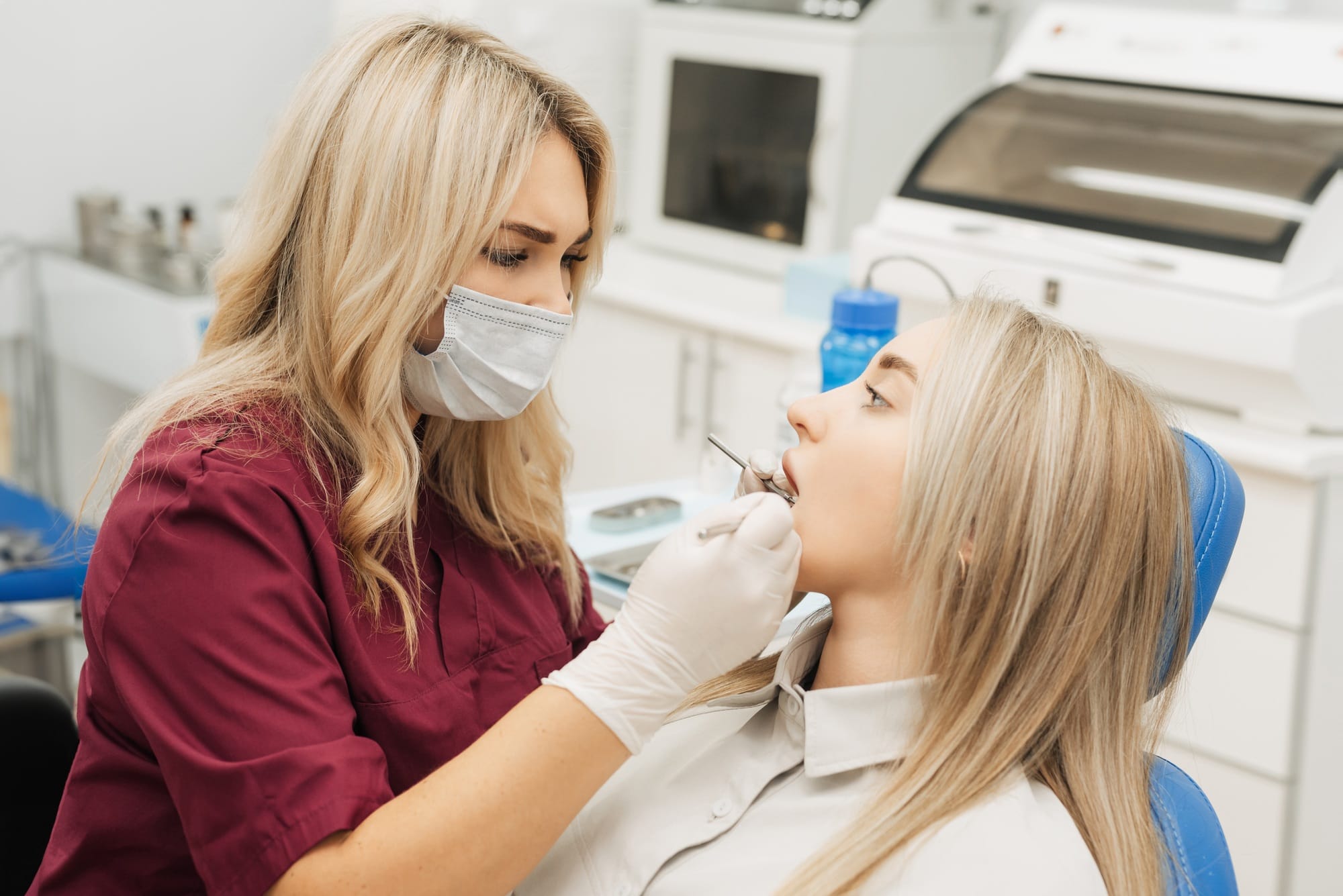 Dentist examining a patient's teeth in the dentist. Dentist examining a patient's teeth in the dentist.