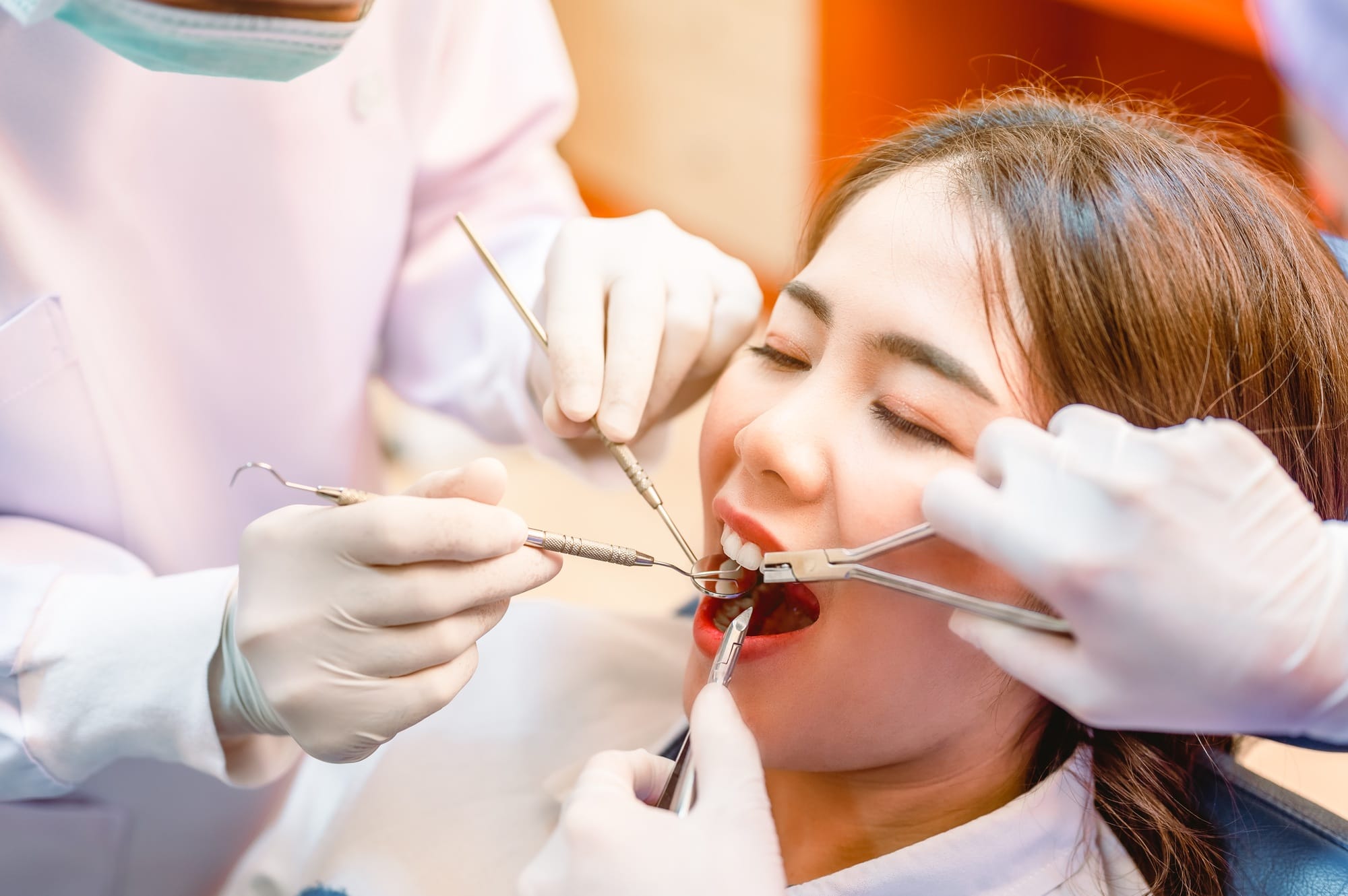 Dentist examining teeth patients in clinic for better dental health and a bright smile.Dentist is ex Dentist examining teeth patients in clinic for better dental health and a bright smile.Dentist is ex