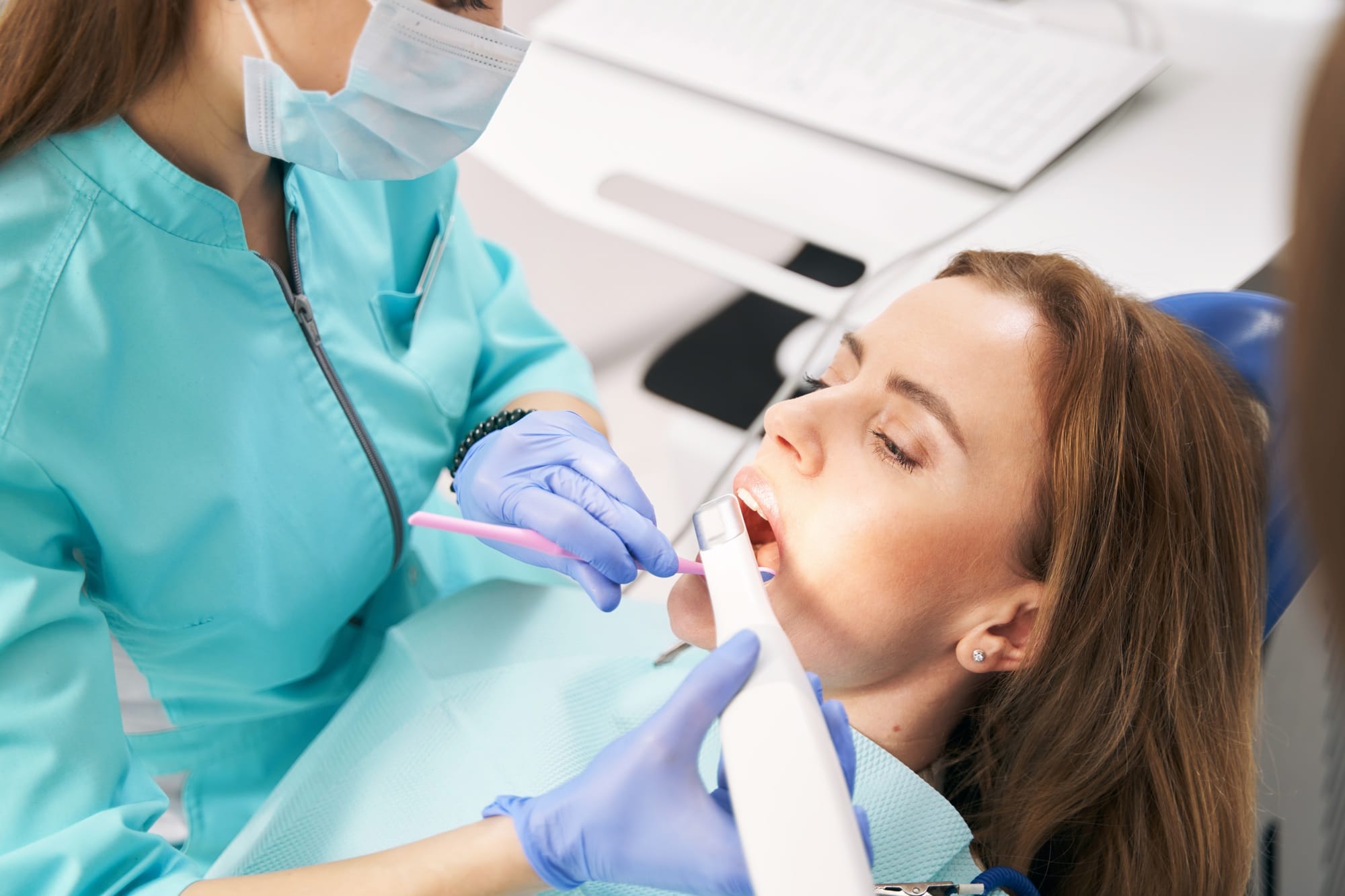 Dentist scanning woman teeth with dental 3D scanner Dentist scanning woman teeth with dental 3D scanner