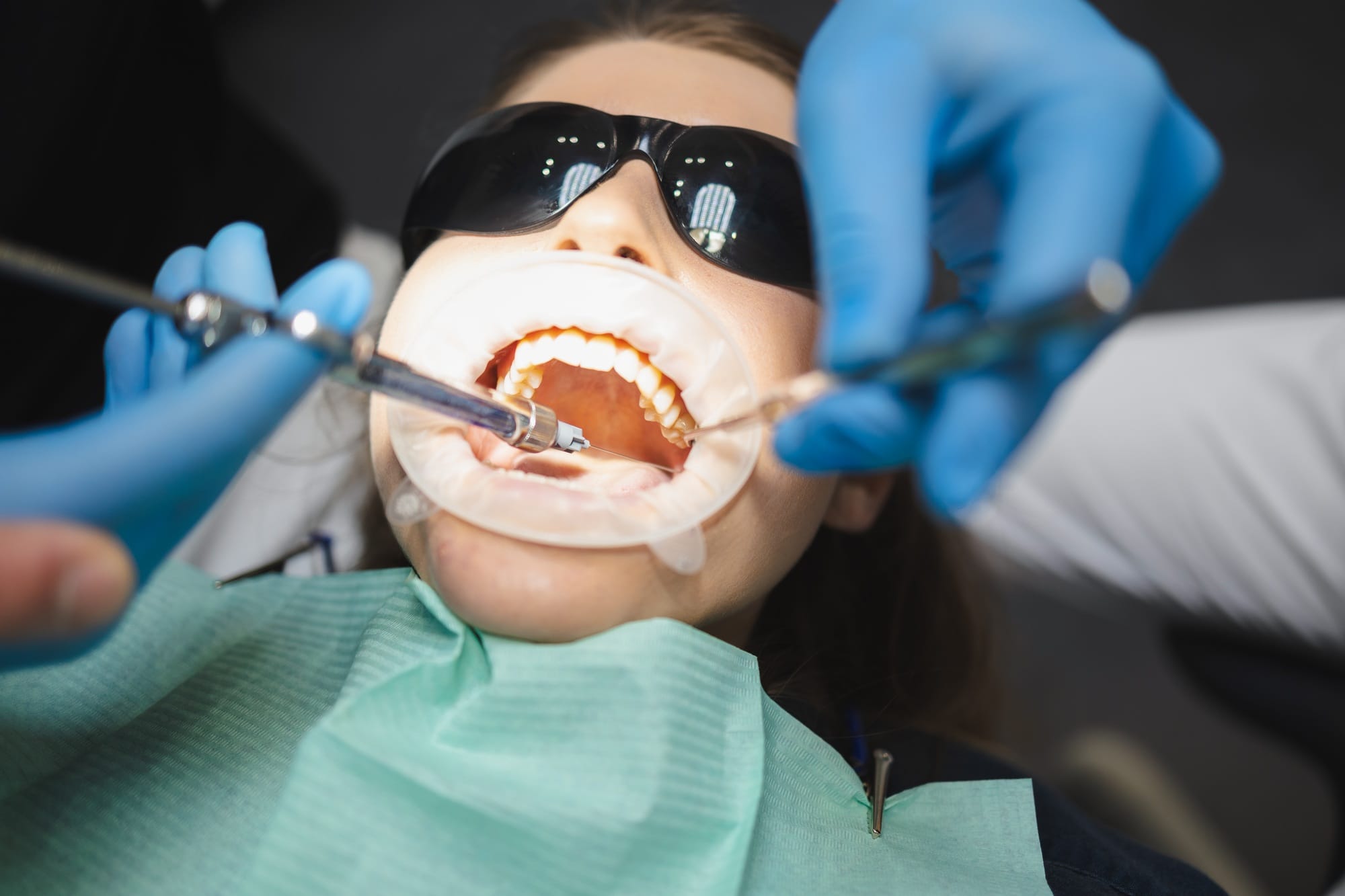 Doctor giving anesthesia to the patient before dental surgery Doctor giving anesthesia to the patient before dental surgery