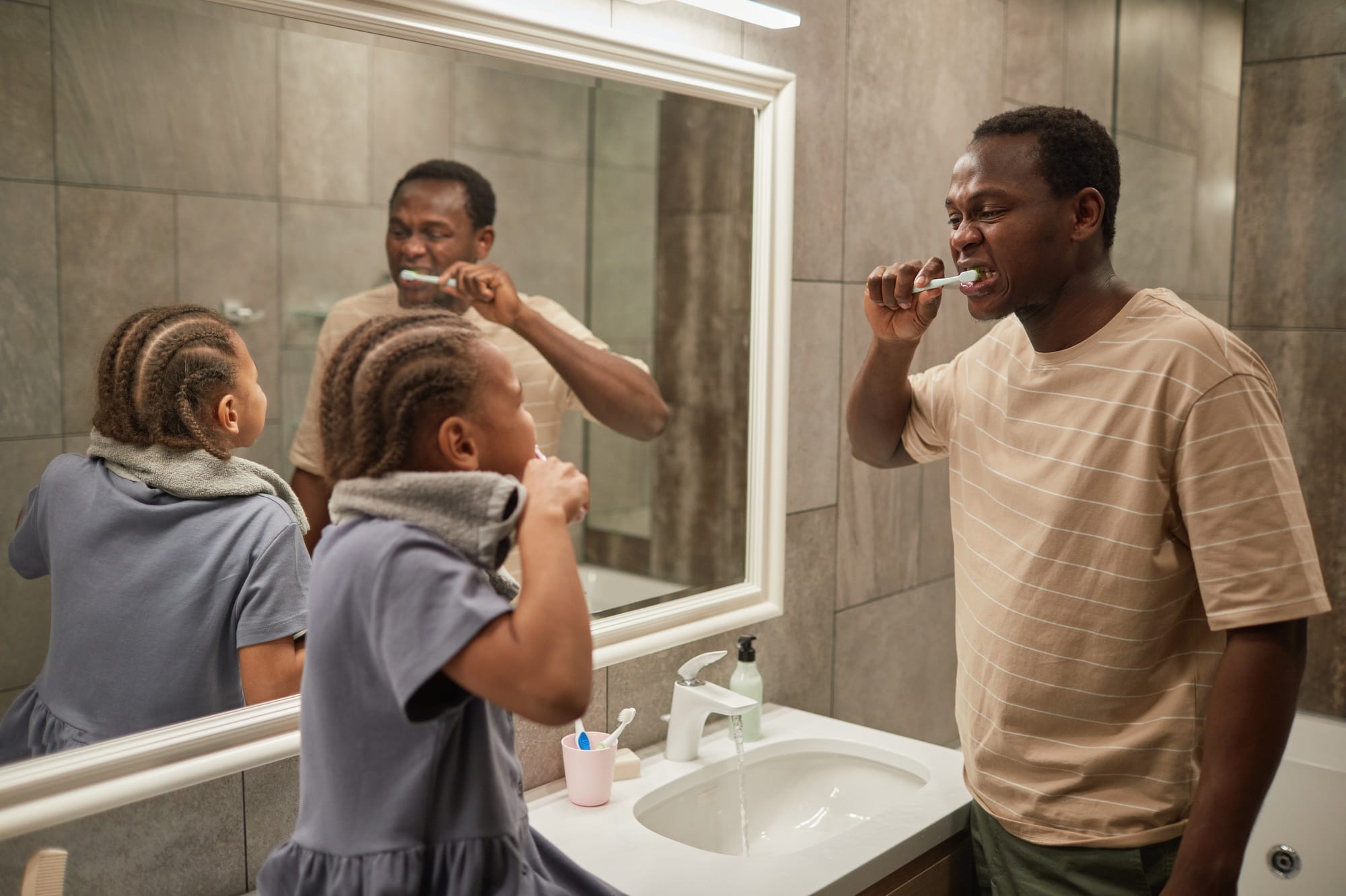 Father and Daughter Brushing Teeth Father and Daughter Brushing Teeth
