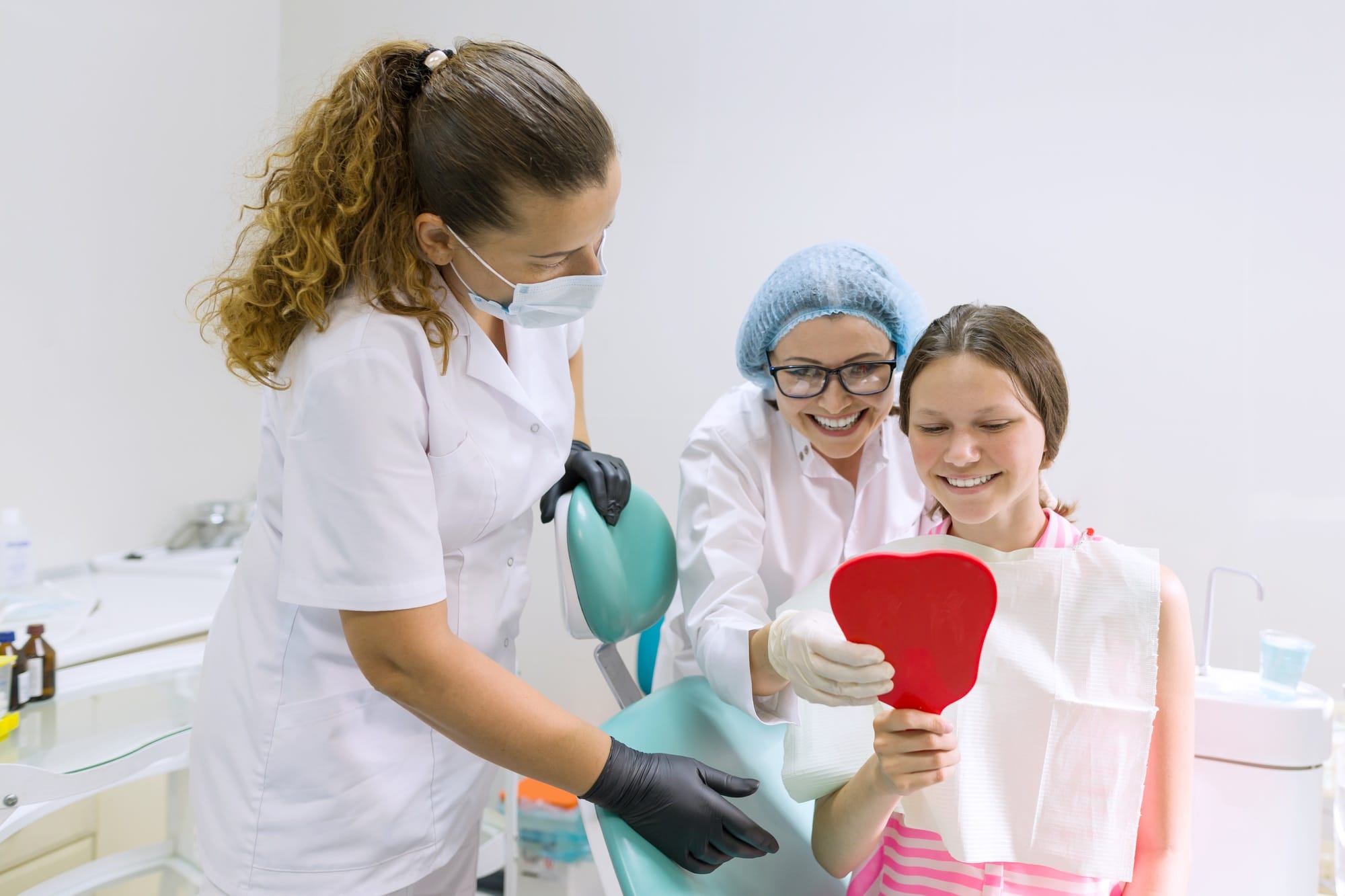 Happy teen girl in dental chair. Medicine, dentistry and healthcare concept Happy teen girl in dental chair. Medicine, dentistry and healthcare concept