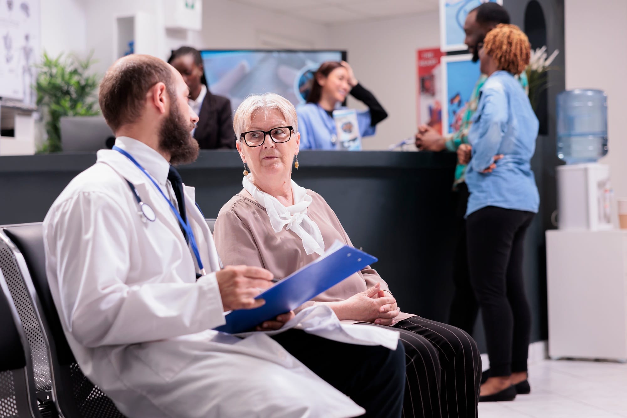 Physician of hospital interviewing old woman Physician of hospital interviewing old woman