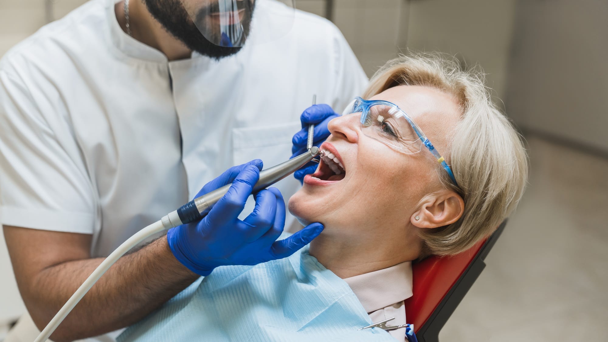 Stomatological equipment, dentist whitening filling tooth teeth of female patient at dental hospital Stomatological equipment, dentist whitening filling tooth teeth of female patient at dental hospital