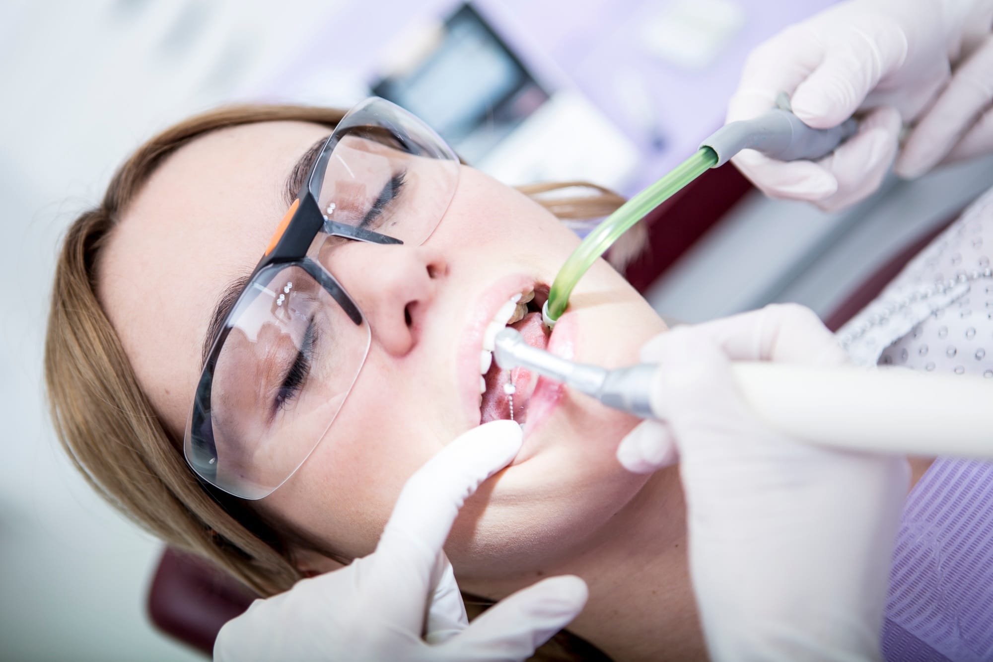 Woman at the dentist receiving root canal treatment Woman at the dentist receiving root canal treatment