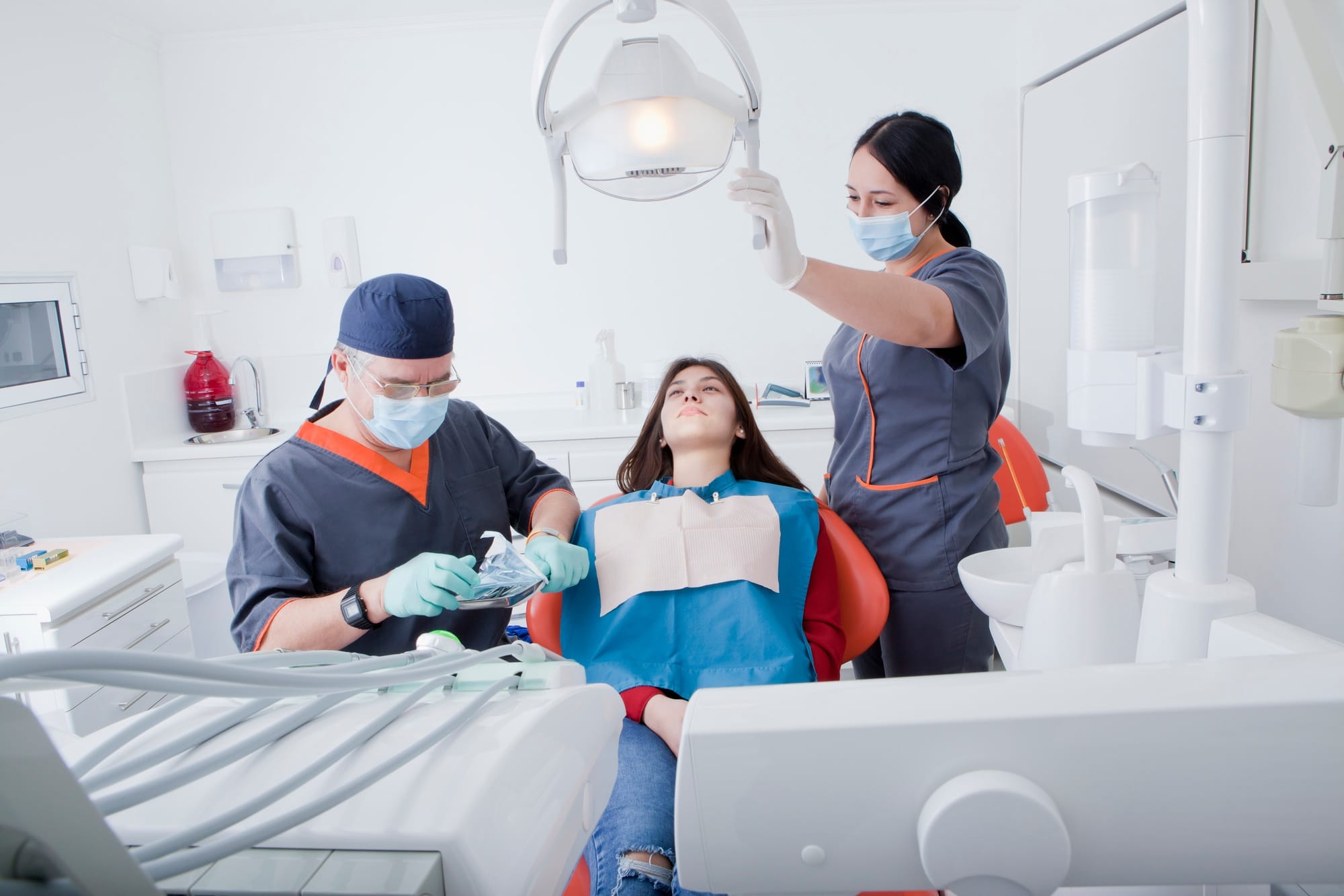 Dentist and dental nurse with patient Dentist and dental nurse with patient