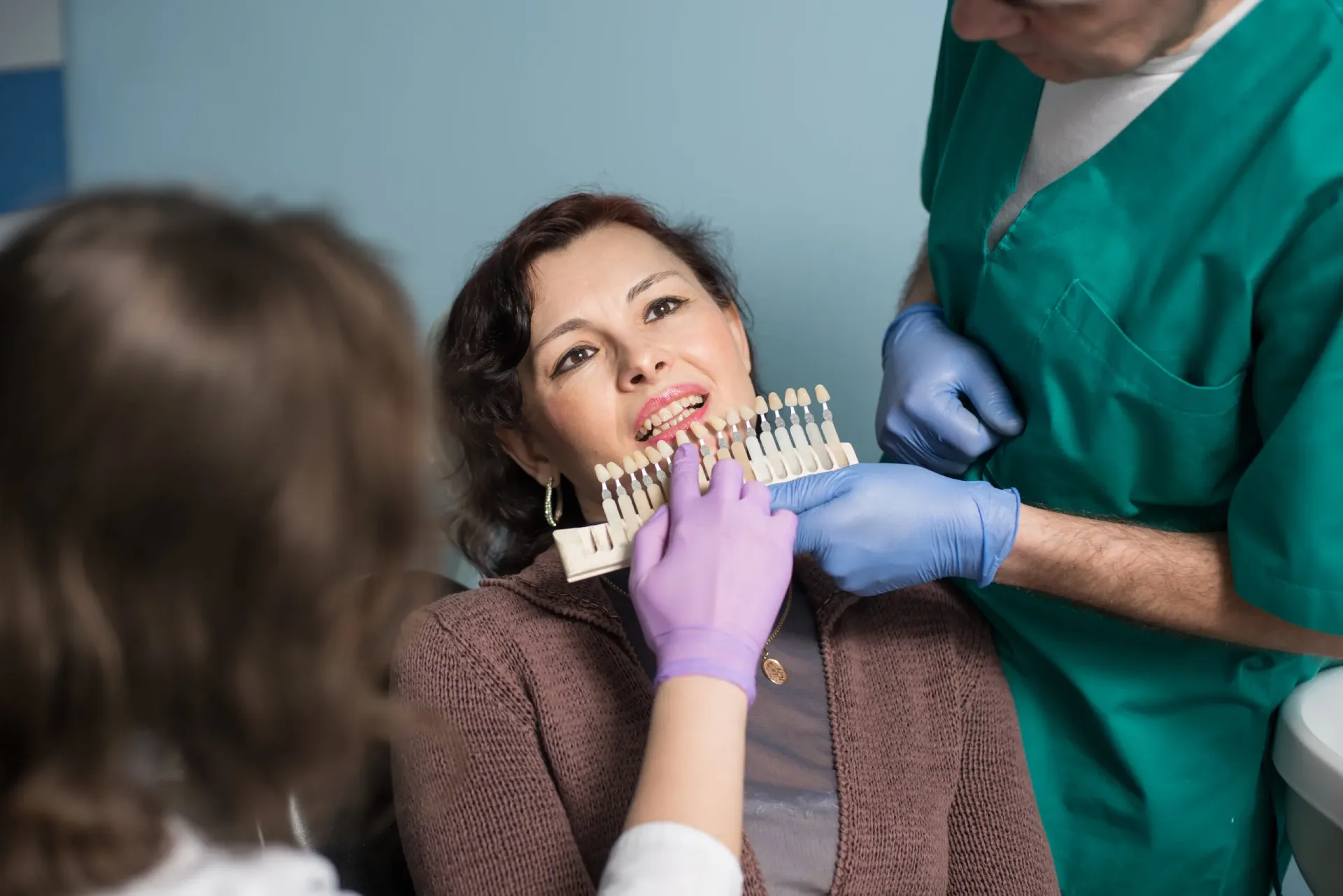 dentist-with-assistant-and-female-patient-checking-2025-02-24-23-04-01-utc-scaled (1)